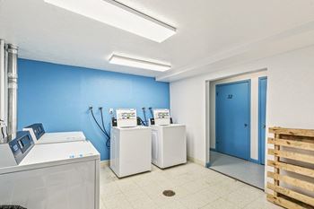 A room with a blue wall and a white door.